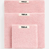 Three soft Terry Towel Washcloth sets in descending sizes, each featuring a centered TEKLA brand label and a matching pink washcloth.