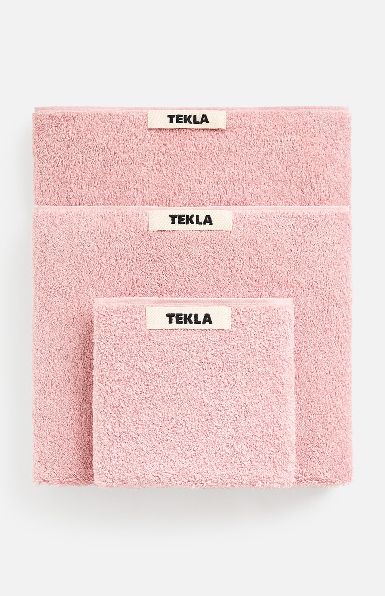Three soft Terry Towel Washcloth sets in descending sizes, each featuring a centered TEKLA brand label and a matching pink washcloth.