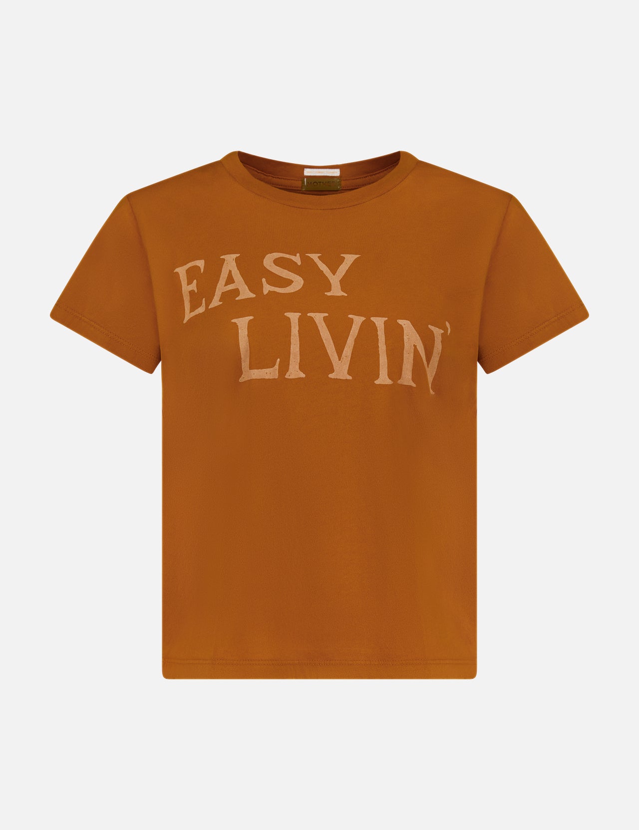 The Boxy Goodie Goodie T-shirt by MOTHER is a rust-colored, slim fit tee with short sleeves and “EASY LIVIN’” printed in large, light beige letters on the chest for a subtle vintage vibe.