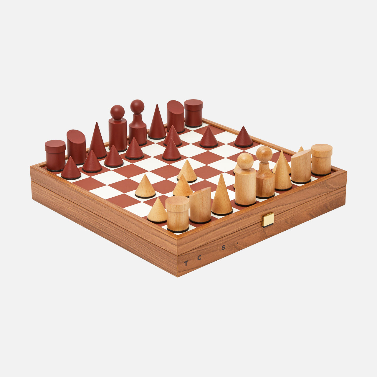 The Milos Terracotta Chess Game Set by THE CONRAN SHOP is a handcrafted set with minimalist, geometric wood pieces in natural and reddish-brown on a square board with a side drawer.