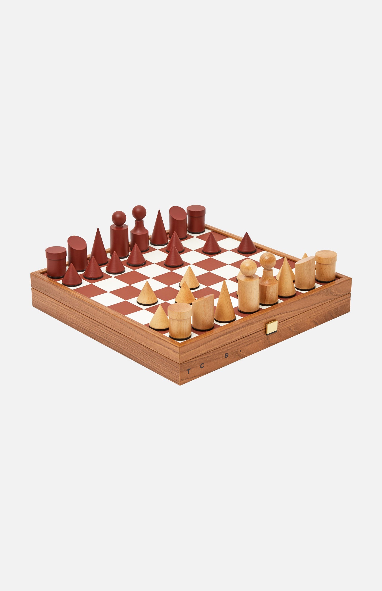 The Milos Terracotta Chess Game Set by THE CONRAN SHOP is a handcrafted set with minimalist, geometric wood pieces in natural and reddish-brown on a square board with a side drawer.