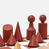 The Milos Terracotta Chess Game Set by THE CONRAN SHOP features a modern minimalist design with geometric brown and tan pieces—cones, cylinders, and spheres—on a handcrafted wooden board for an abstract, elegant look.