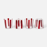The Nova Stripe Tumbler Set of 4 by THE CONRAN SHOP features clear crystal glasses with vertical red stripes, arranged in a row on a white background; the rightmost tumbler is upside down, showcasing the striped design from another angle.