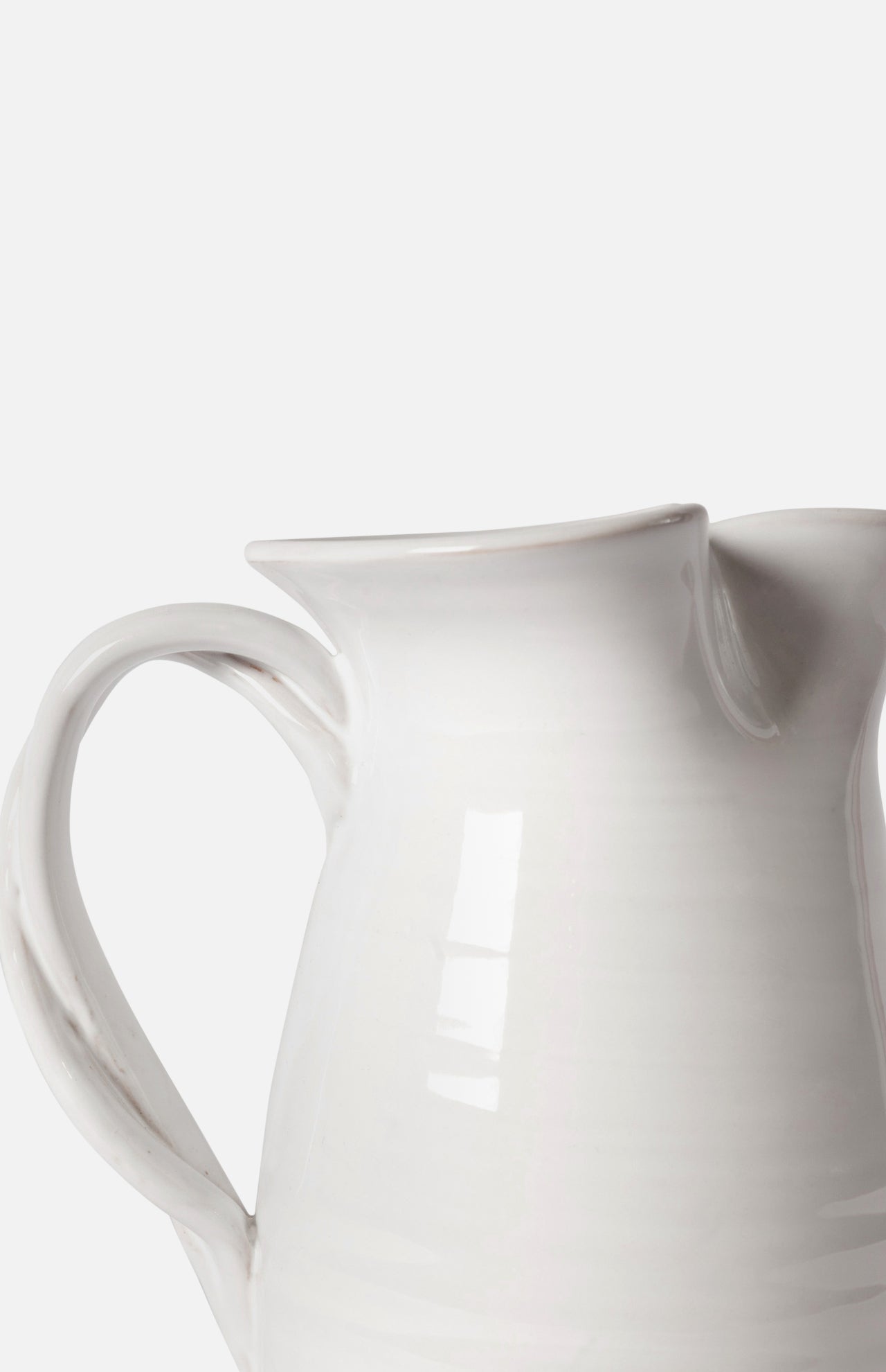A close-up of THE CONRAN SHOP's Puglia Jug with Plaited Handle, featuring a white stoneware body, handle, and spout, set against a plain background—an elegant handcrafted ceramic piece from Italy.