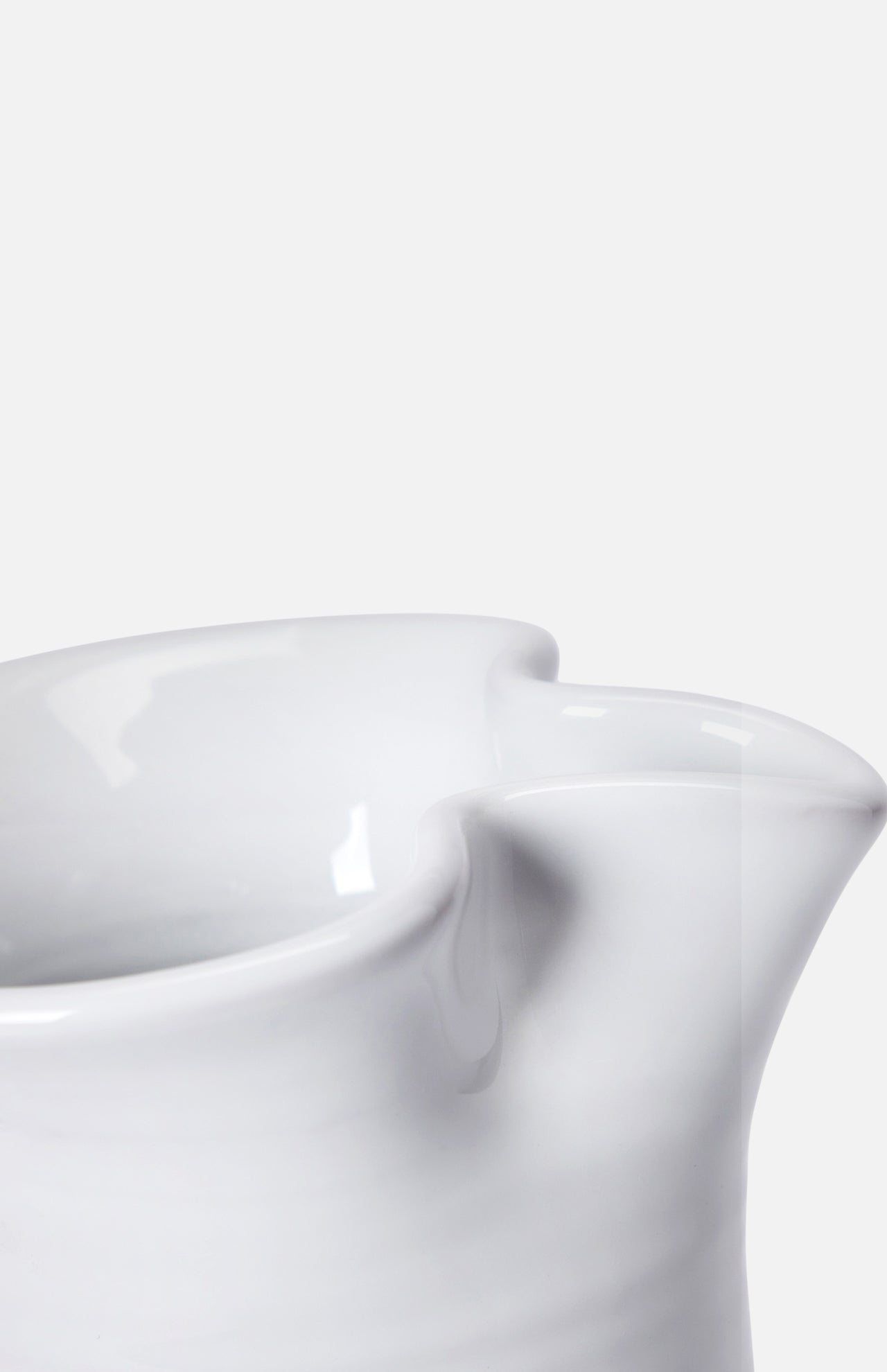 Close-up of THE CONRAN SHOP Puglia Jug with Ring Handle, a white ceramic piece featuring a glossy finish and prominent spout, inspired by traditional Puglia craftsmanship, set against a plain white background.