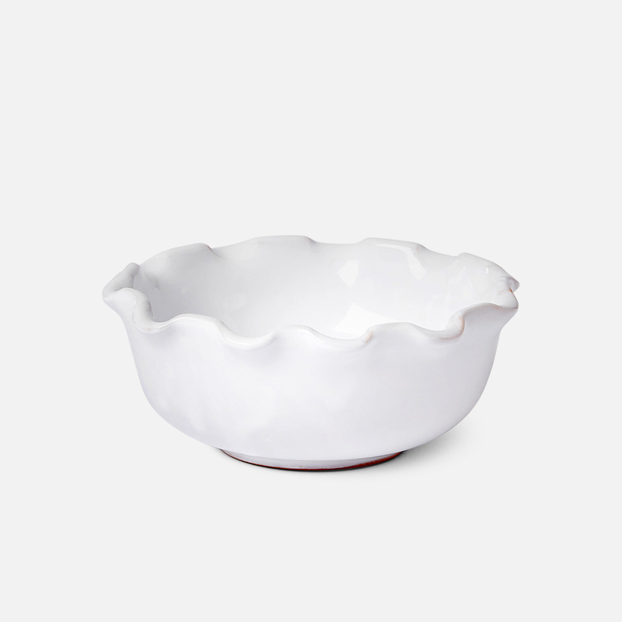 The Puglia Scalloped Small Bowl by THE CONRAN SHOP, crafted in white stoneware with scalloped edges and a glossy finish, sits on a plain white background, highlighting the timeless elegance of handcrafted Italian design.