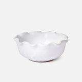 The Puglia Scalloped Small Bowl by THE CONRAN SHOP, crafted in white stoneware with scalloped edges and a glossy finish, sits on a plain white background, highlighting the timeless elegance of handcrafted Italian design.
