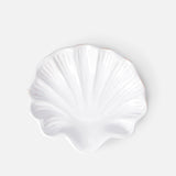 The Puglia Stoneware Shell Dish by THE CONRAN SHOP, shaped like a seashell, brings elegant coastal charm to any space with its handcrafted Italian ceramic design and light gray background.