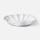 The Puglia Stoneware Shell Dish by THE CONRAN SHOP features gentle ridges and a glossy finish, handcrafted in Italy—ideal for bringing coastal charm to any space. Displayed against a plain light background.
