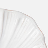 Close-up of THE CONRAN SHOP's Puglia Stoneware Shell Dish, featuring a scalloped shell-inspired edge in white—perfect for coastal decor—set against a plain light gray background.