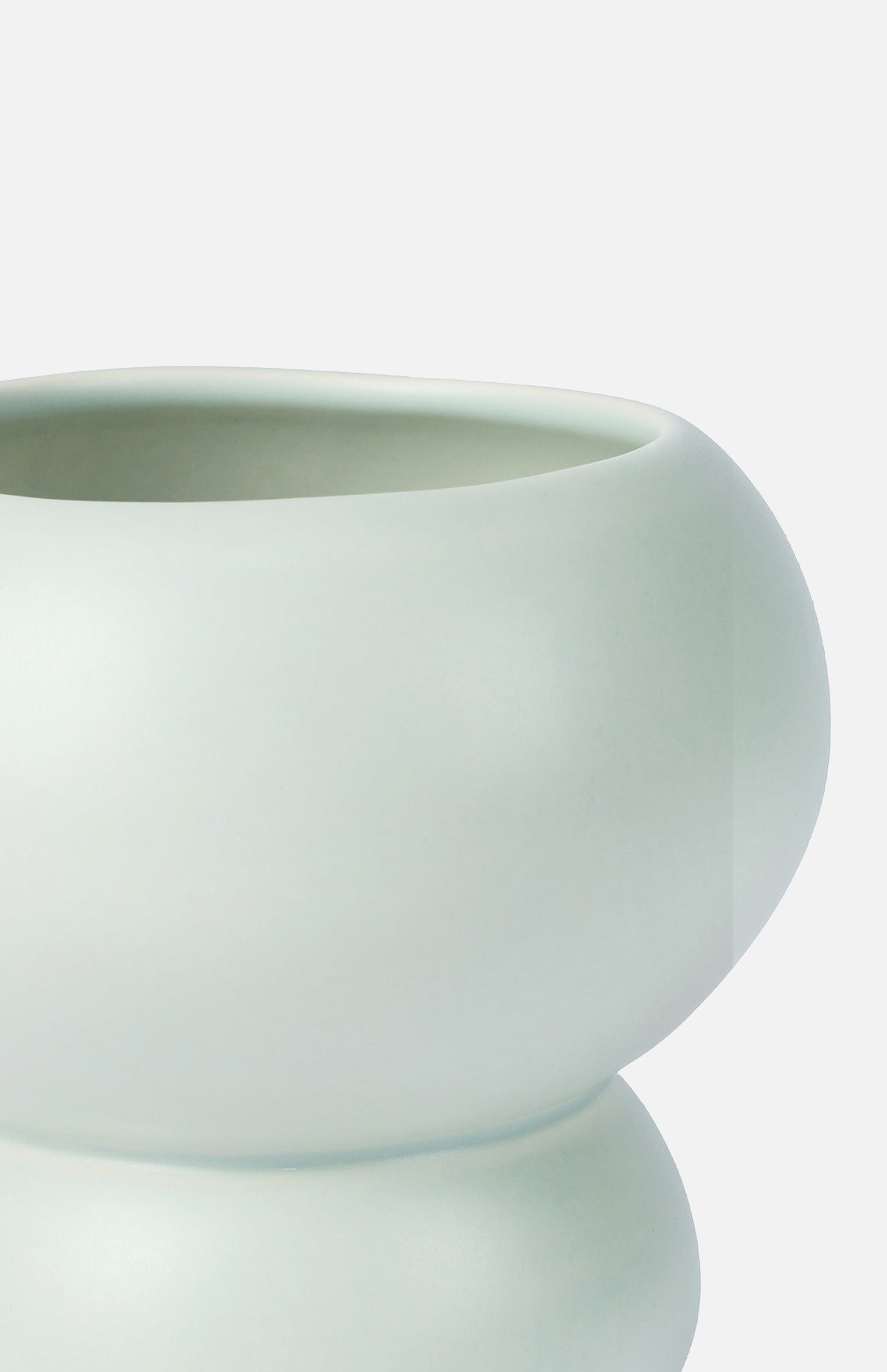 Close-up of the Stacked Spheres Vase Mint by THE CONRAN SHOP—a modern, matte ceramic piece with smooth, rounded curves. Its minimalist design echoes Arjan Van Dal’s refined earthenware style against a plain white background.