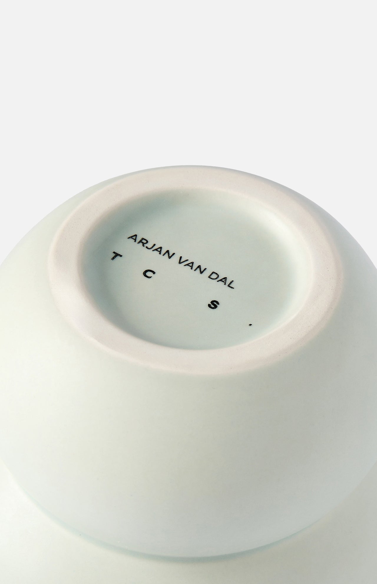 Close-up of the bottom of a white ceramic Stacked Spheres Vase Mint by THE CONRAN SHOP, with branding printed in black on the base, mirroring the signature style found on similar pieces.