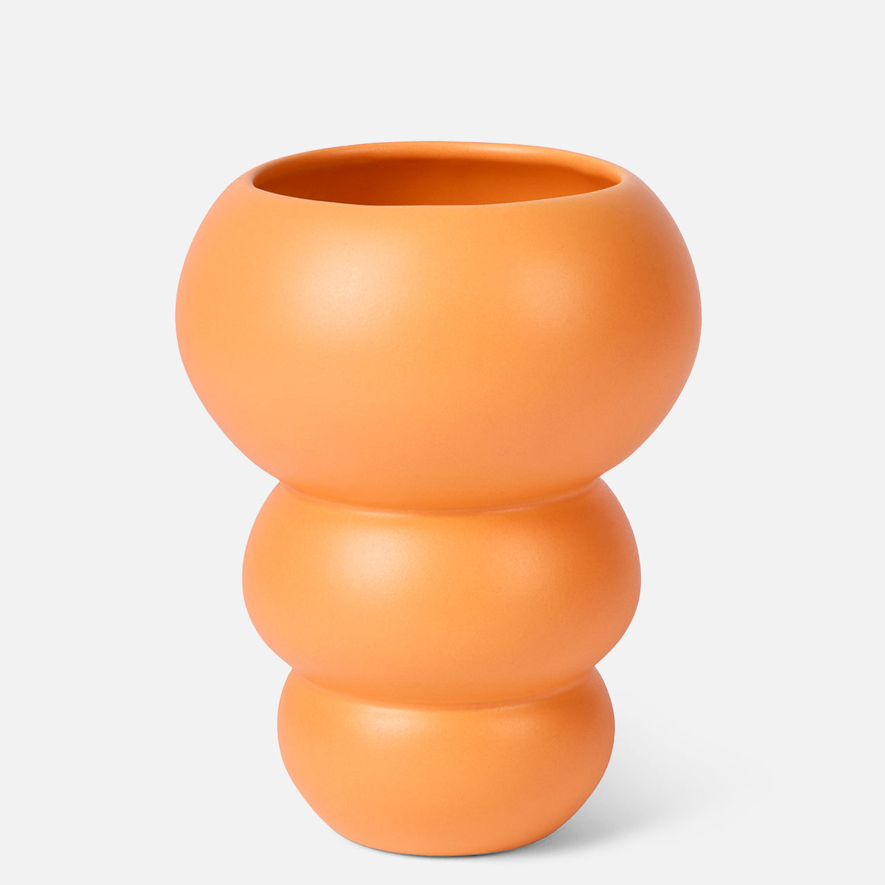 The Stacked Spheres Vase Orange by THE CONRAN SHOP features a matte, three-tiered earthenware design in tangerine, shown against a plain light background.