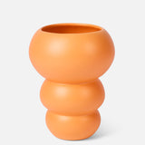 The Stacked Spheres Vase Orange by THE CONRAN SHOP features a matte, three-tiered earthenware design in tangerine, shown against a plain light background.