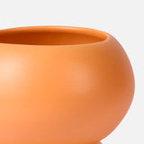 A close-up of THE CONRAN SHOP’s Stacked Spheres Vase Orange showcases its smooth, curved earthenware form against a plain white background.