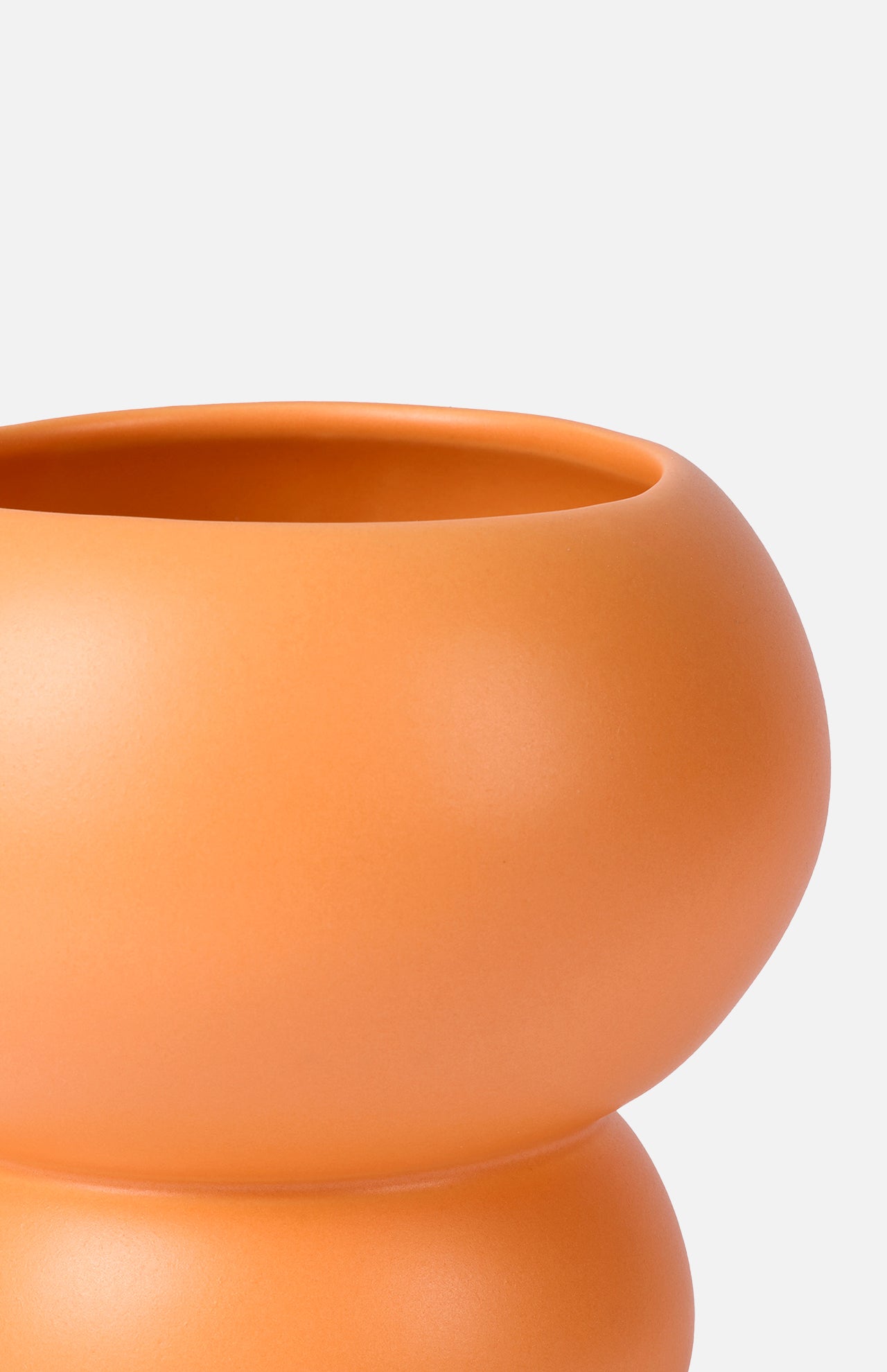 A close-up of THE CONRAN SHOP’s Stacked Spheres Vase Orange showcases its smooth, curved earthenware form against a plain white background.