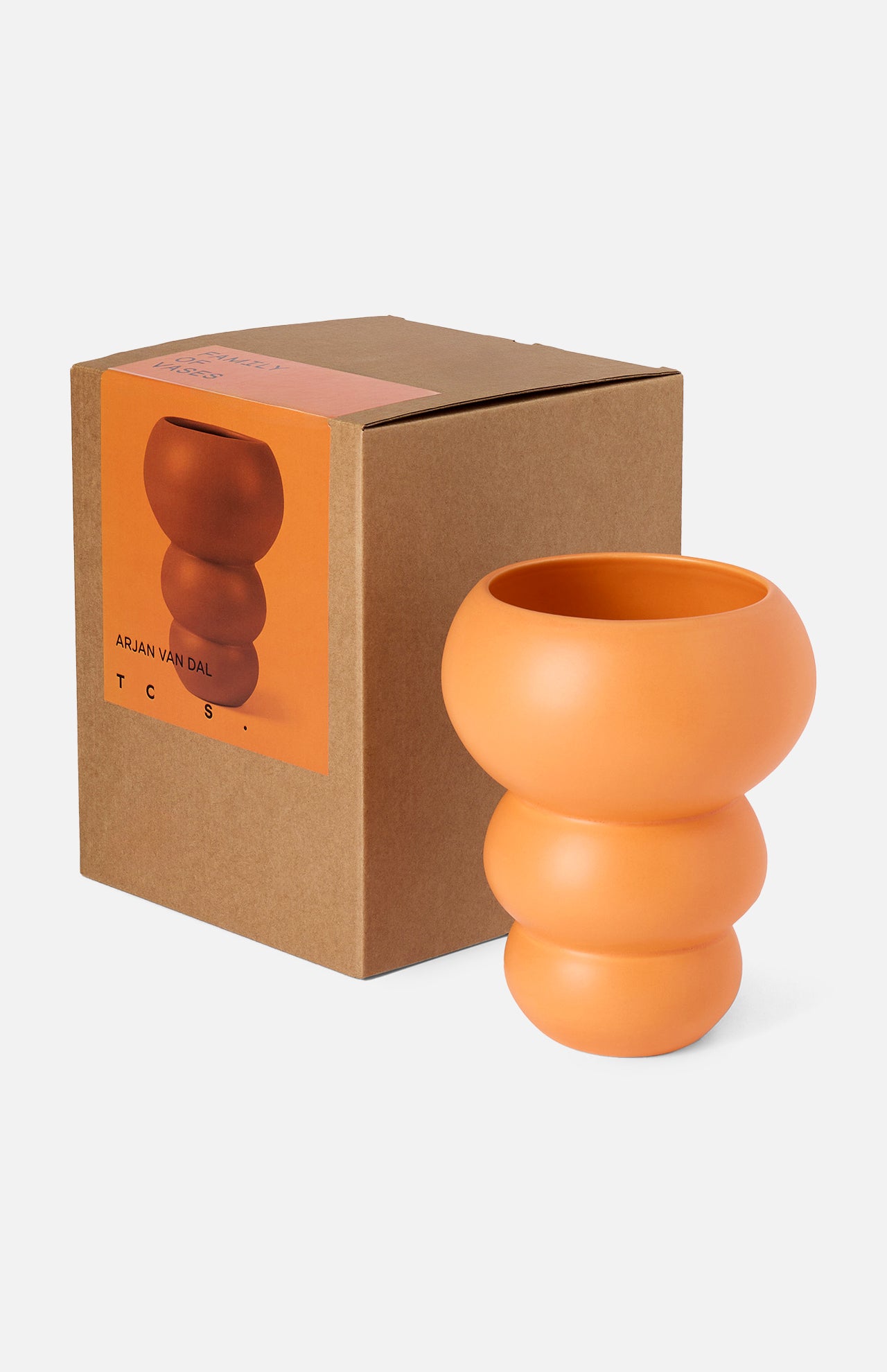 The CONRAN SHOP's Stacked Spheres Vase Orange, crafted in sculptural earthenware with three rounded segments, is shown beside its brown box featuring a product image and description on the front.