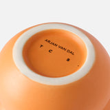 The Stacked Spheres Vase Orange by THE CONRAN SHOP is shown from the bottom, revealing a white rim and "THE CONRAN SHOP" printed in black on its base.