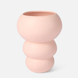 The Stacked Spheres Vase Plaster by THE CONRAN SHOP is a pale pink earthenware piece with a matte finish, featuring three rounded, stacked sections and a wide opening, shown against a plain white background.