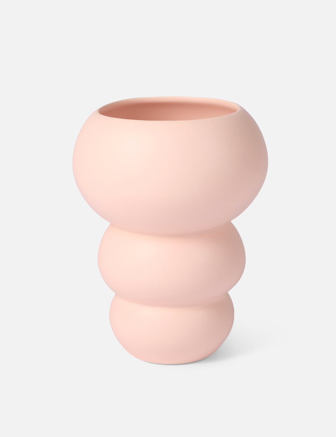 The Stacked Spheres Vase Plaster by THE CONRAN SHOP is a pale pink earthenware piece with a matte finish, featuring three rounded, stacked sections and a wide opening, shown against a plain white background.