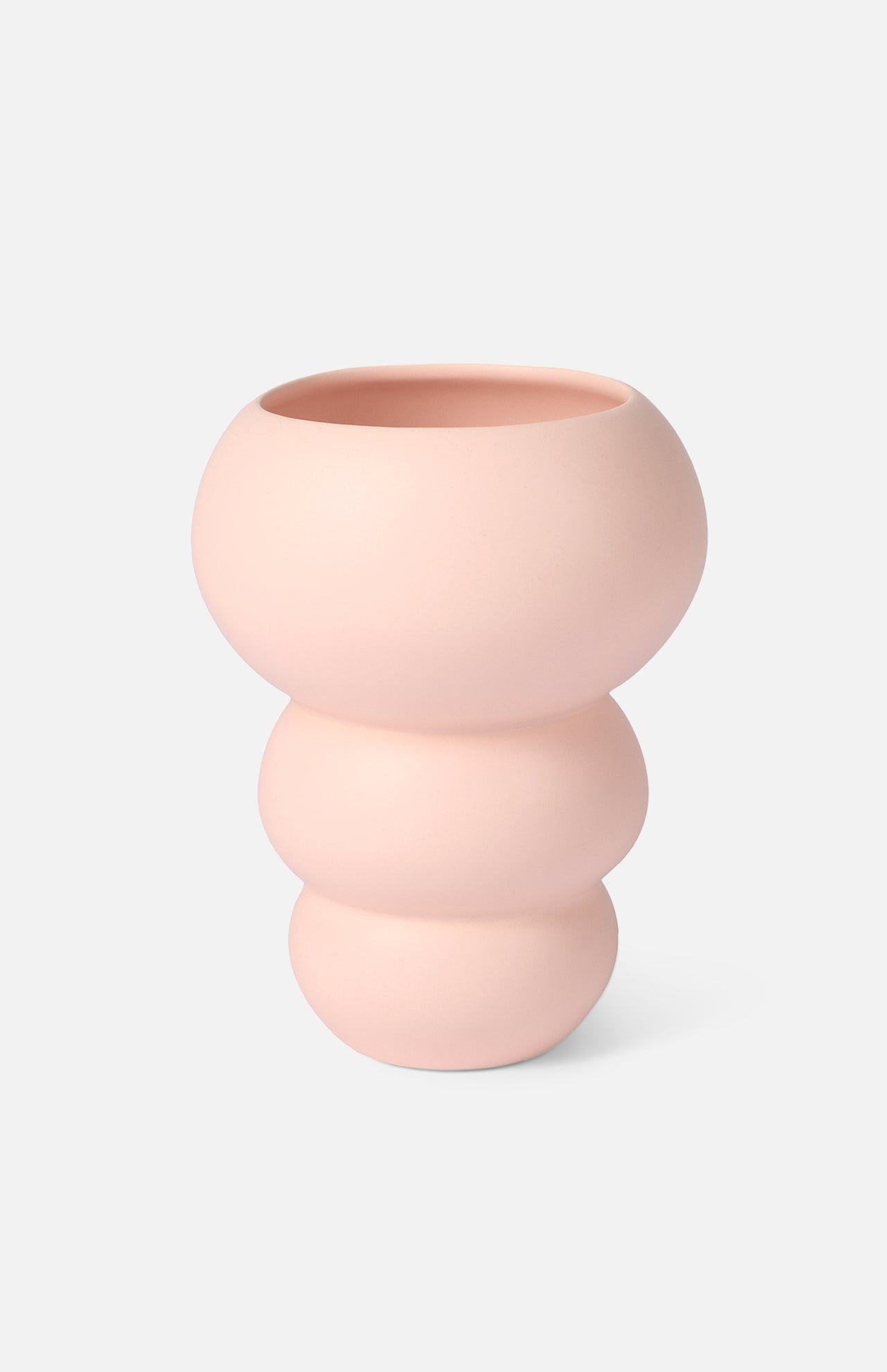 The Stacked Spheres Vase Plaster by THE CONRAN SHOP is a pale pink earthenware piece with a matte finish, featuring three rounded, stacked sections and a wide opening, shown against a plain white background.