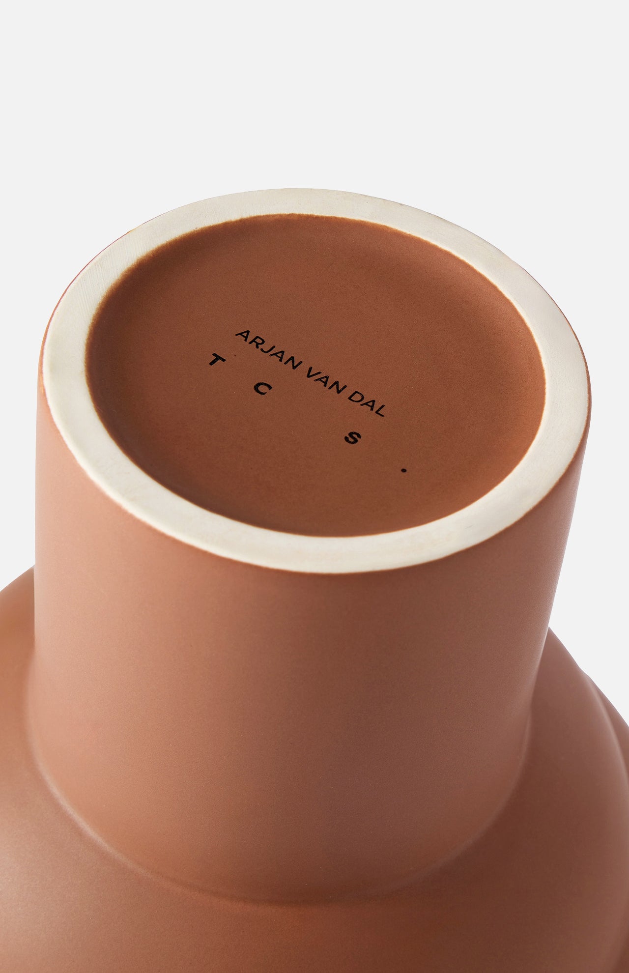 Close-up of the base of the Tree Vase Cocao by THE CONRAN SHOP, matte brown finish, with branding printed in black and viewed from below against a white background.