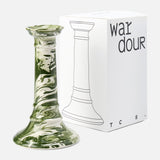The Marbled Wardour Candlestick by THE CONRAN SHOP, featuring a green and white hand-marbled glaze, stands beside its white box decorated with a black line drawing and "wardour" text on the front.