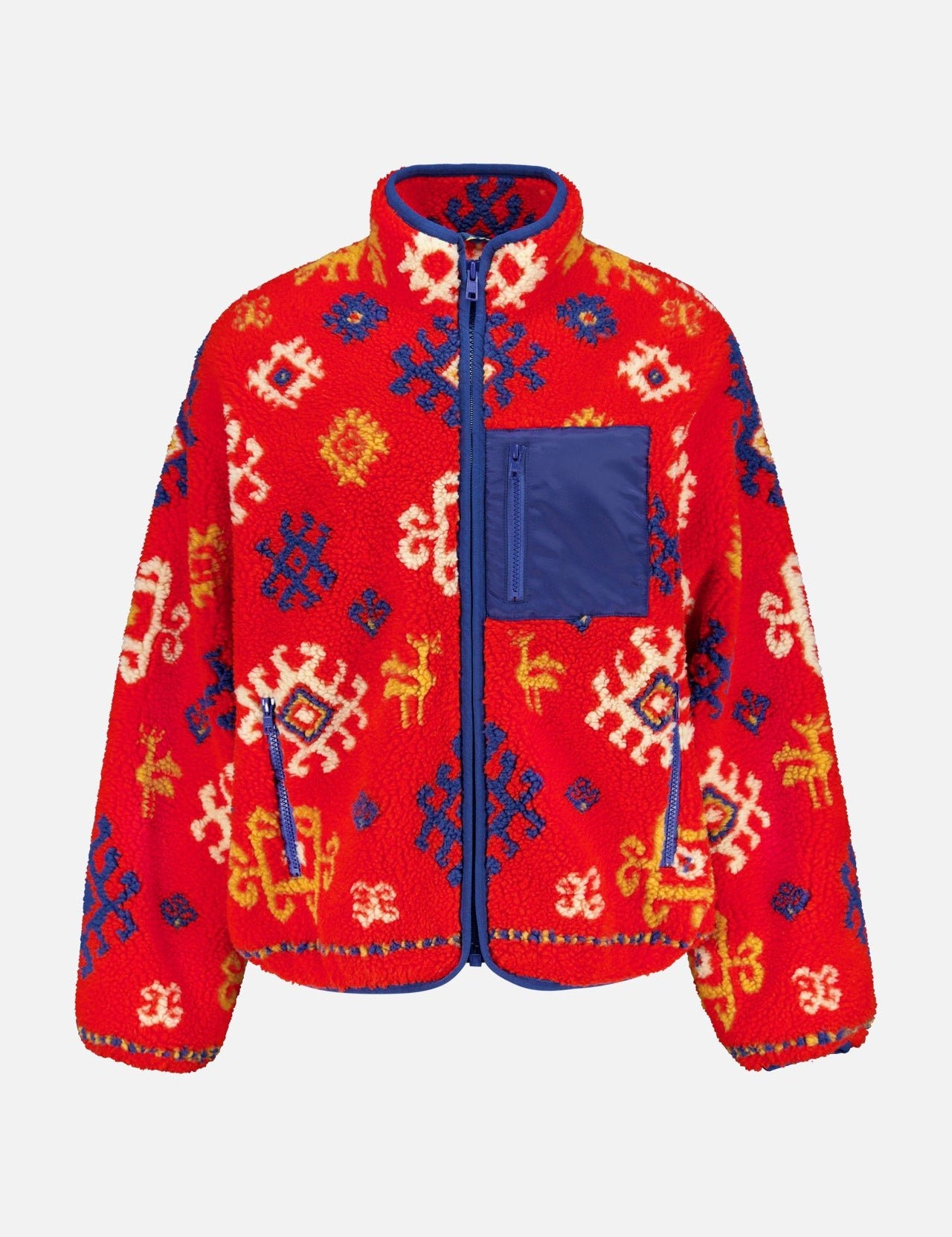 The Heat Lamp Fleece Jacket by MOTHER is a vibrant red fleece outerwear with long sleeves, high collar, blue front zipper and trim, a blue chest pocket, and folk art-inspired white, yellow, and navy patterns.
