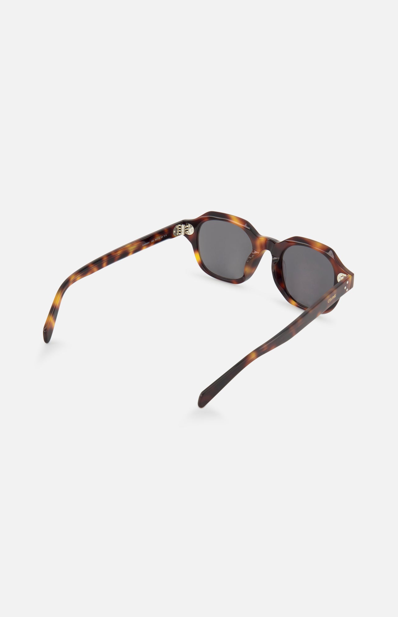 The CELINE Round Brown Tortoiseshell Sunglasses feature dark lenses and a classic tortoiseshell finish, shown from the rear on a white background—an elegant example of French luxury eyewear.