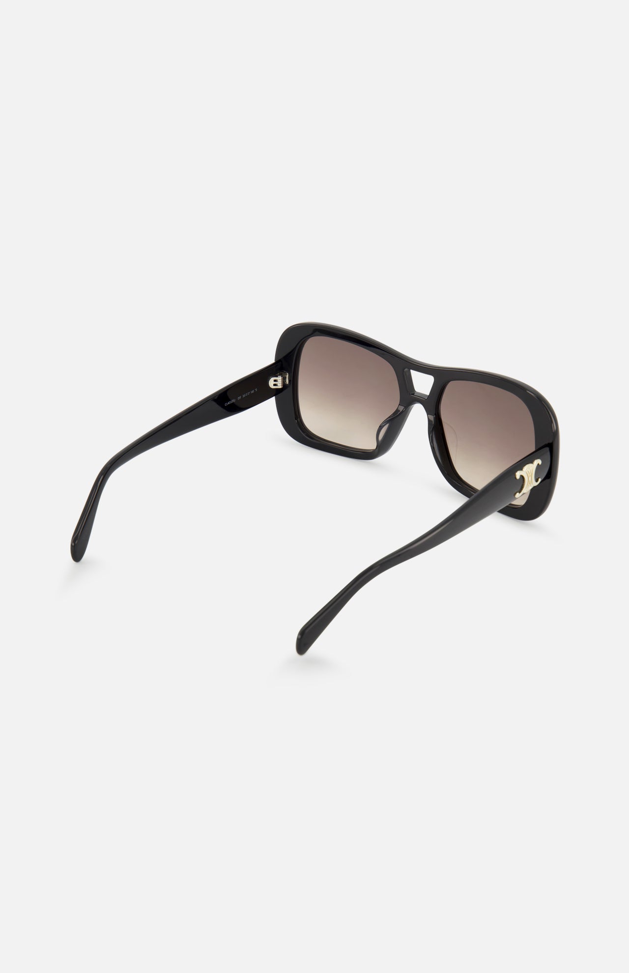 The Celine Aviator Black Sunglasses by CELINE are shown from the back, featuring black square frames with brown gradient lenses and metallic accents on the arms, all set against a plain white background.
