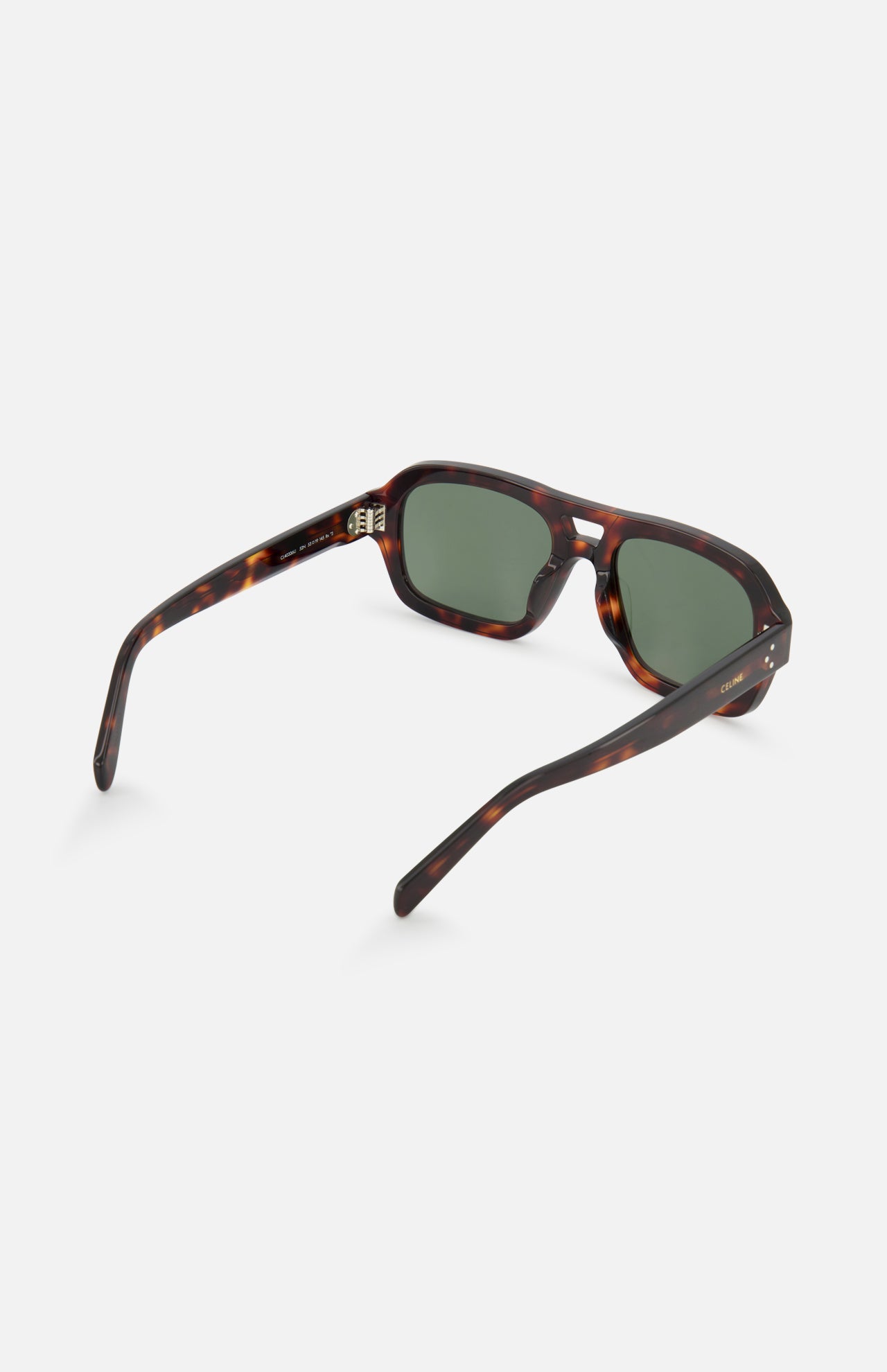 The CELINE Aviator Brown Tortoiseshell Sunglasses feature green lenses and slightly curved arms, displayed from a rear/side angle on a white background. The visible inside hinge reflects classic French luxury style.