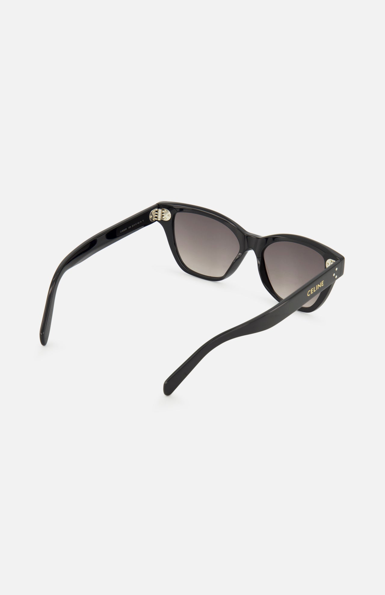 CELINE Cat Eye Black Sunglasses, featuring luxurious acetate frames with gradient dark lenses, are displayed from a rear angle against a plain white background. The open arms highlight the CELINE logo in gold on the left temple—an elegant accessory crafted in Italy.