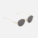 CELINE Celine Round Gold Sunglasses feature thin gold metal frames and dark tinted lenses, elegantly displayed on a white background at a slight angle.
