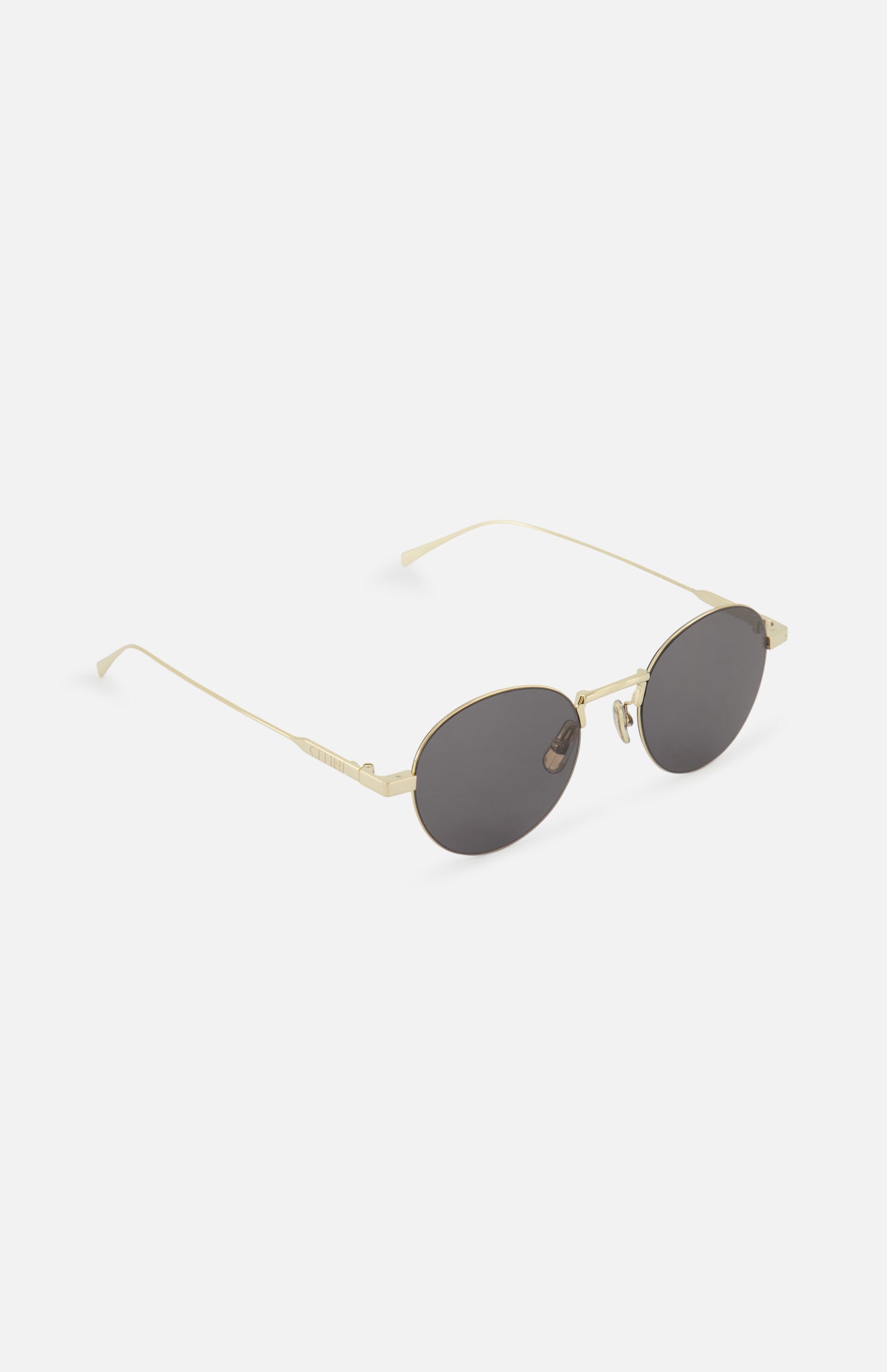 CELINE Celine Round Gold Sunglasses feature thin gold metal frames and dark tinted lenses, elegantly displayed on a white background at a slight angle.