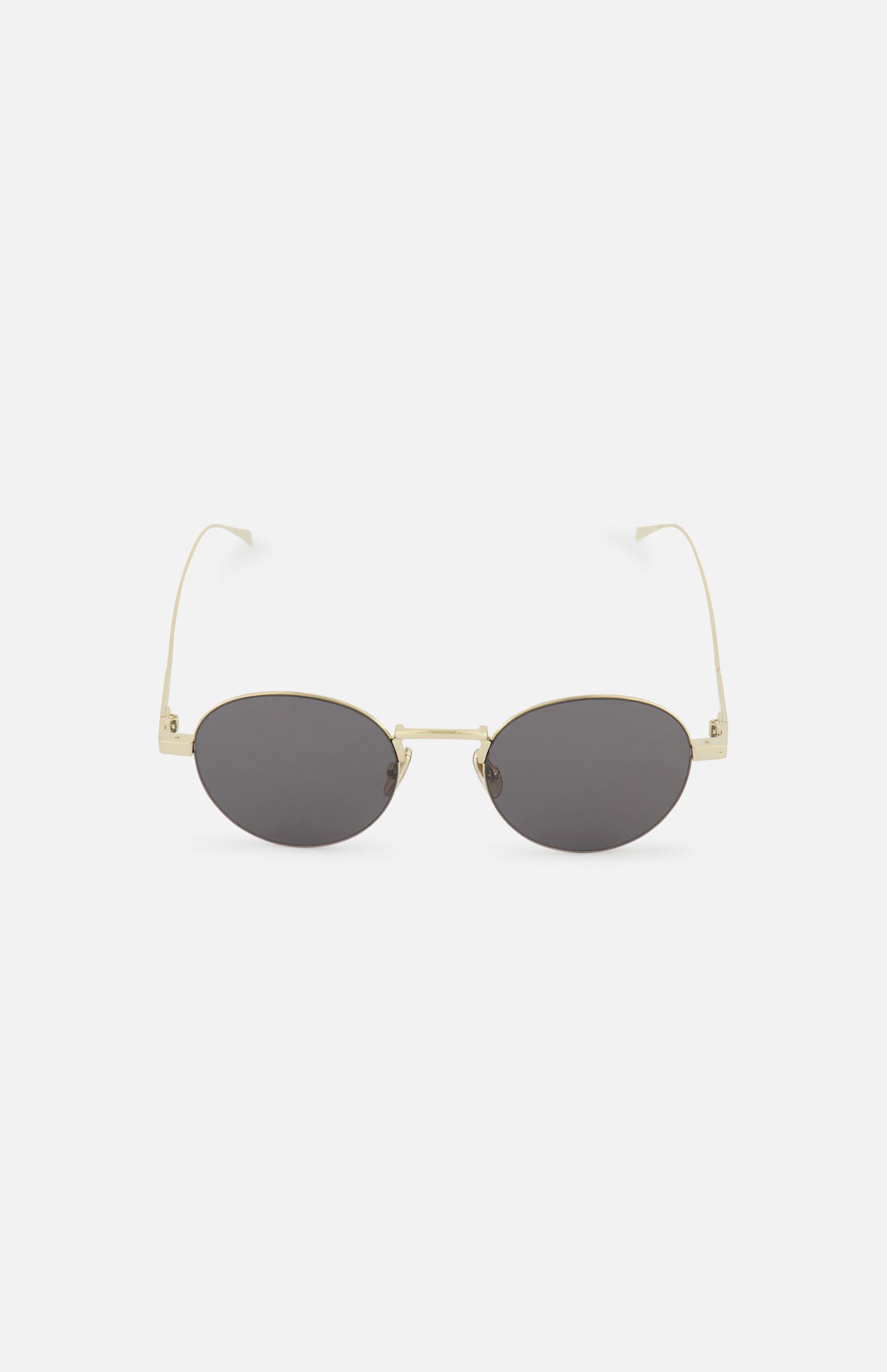 The CELINE Celine Round Gold Sunglasses feature oval-shaped dark lenses and thin gold metal frames, reflecting the timeless elegance of the French fashion house. Shown on a white background.