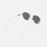 CELINE Round Gold Sunglasses feature gold frames, dark lenses, thin metal arms, and adjustable nose pads, capturing timeless French elegance on a white background.