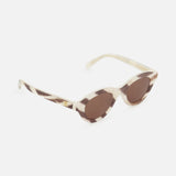 CELINE Celine Round Animal Print Sunglasses in cream and brown feature a marbled animal print pattern, oval cat-eye lenses, and gold accents on the arms, shown against a white background.