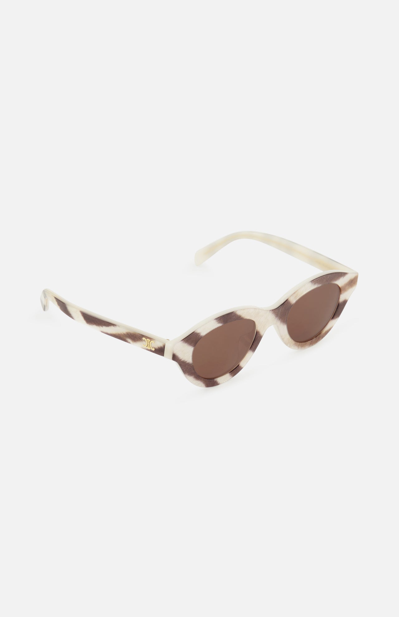CELINE Celine Round Animal Print Sunglasses in cream and brown feature a marbled animal print pattern, oval cat-eye lenses, and gold accents on the arms, shown against a white background.