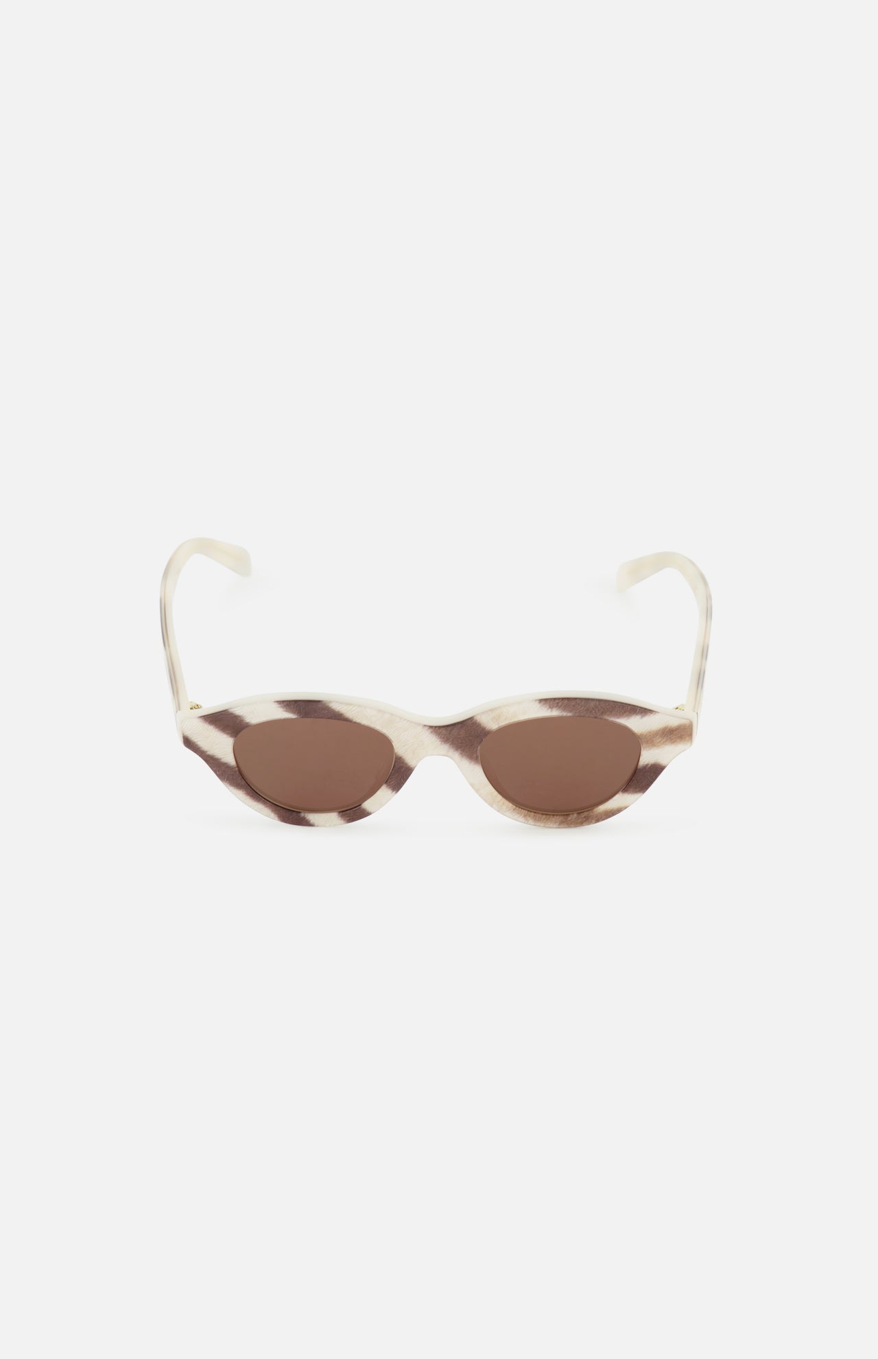 The CELINE Round Animal Print Sunglasses feature a cat-eye silhouette with cream and brown tortoiseshell frames and brown tinted lenses, crafted in Italy and showcased against a white background.