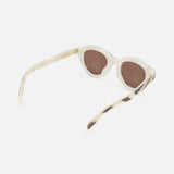 Celine Round Animal Print Sunglasses by CELINE, featuring a beige cat-eye frame with brown lenses and made in Italy, are displayed at an angle to showcase the front and one side against a plain white background.