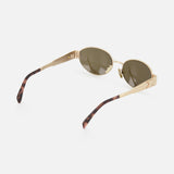 The CELINE Celine Oval Gold Sunglasses feature gold metal frames, green-tinted oval lenses, and thin arms with tortoiseshell-patterned tips. Inspired by a French fashion house, they are displayed on a white background.
