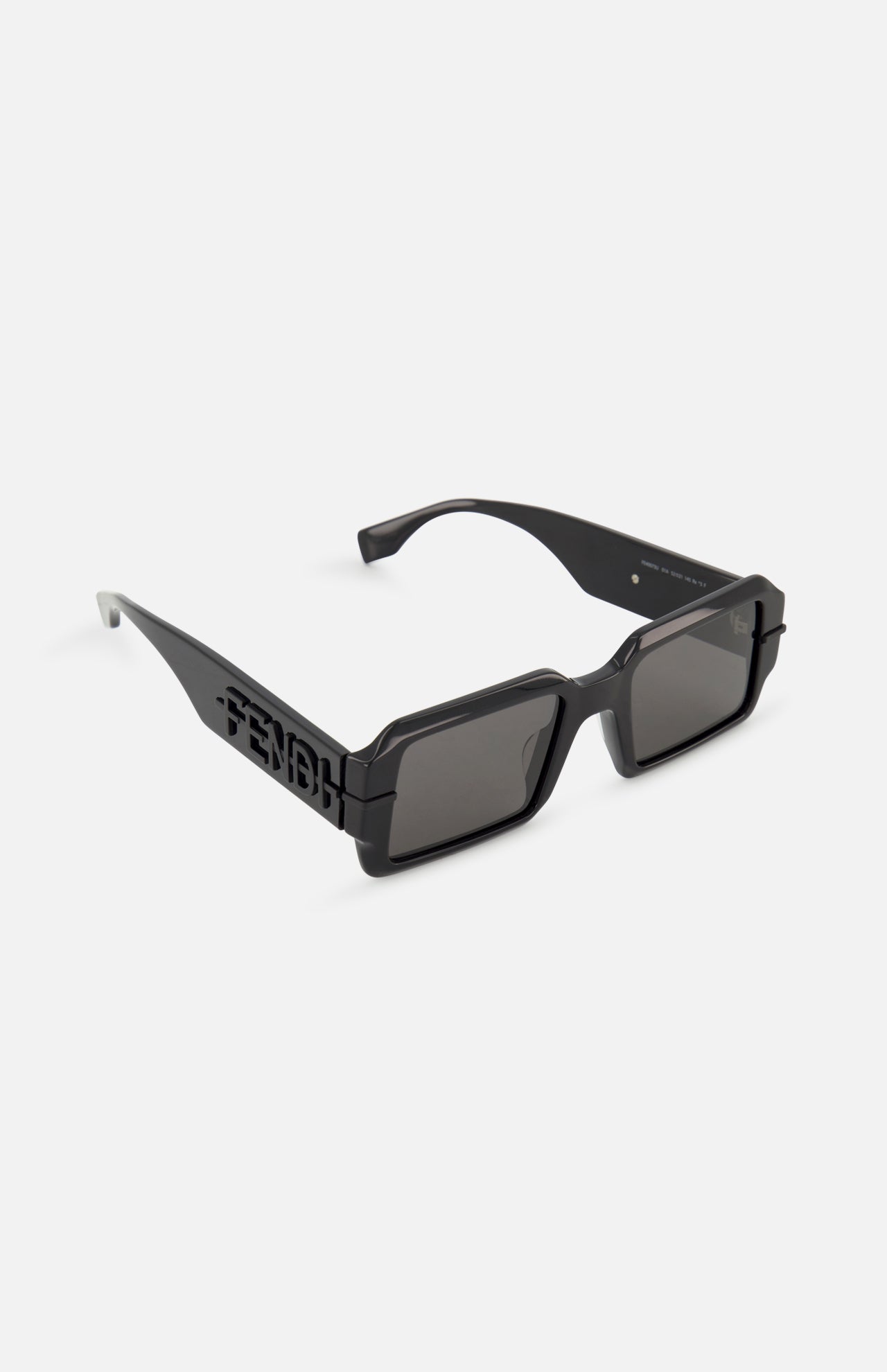 Fendi Rectangular Black Sunglasses by FENDI feature thick-edged black frames, dark lenses, and bold Fendi lettering cut out on the temples. Displayed against a plain white background.