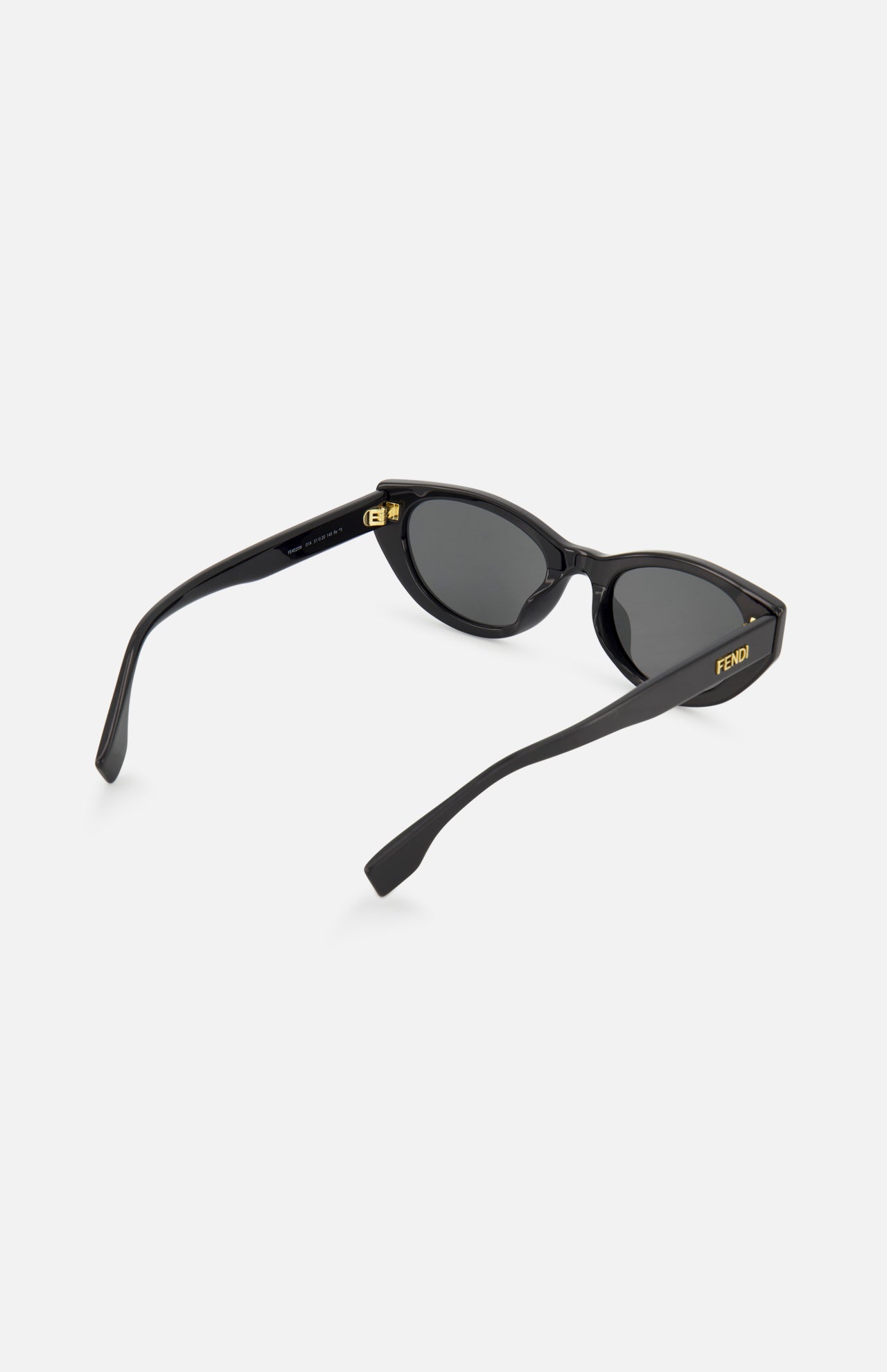 The Fendi Cat Eye Black Sunglasses by FENDI feature dark lenses, a gold logo on the temple, and curved arms—stylish black designer eyewear shown against a white background.