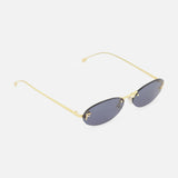 The FENDI Oval Gold Sunglasses are gold-framed, rimless statement sunglasses with subtle gold Fendi lettering and oval dark lenses, showcased from an angle against a plain white background.