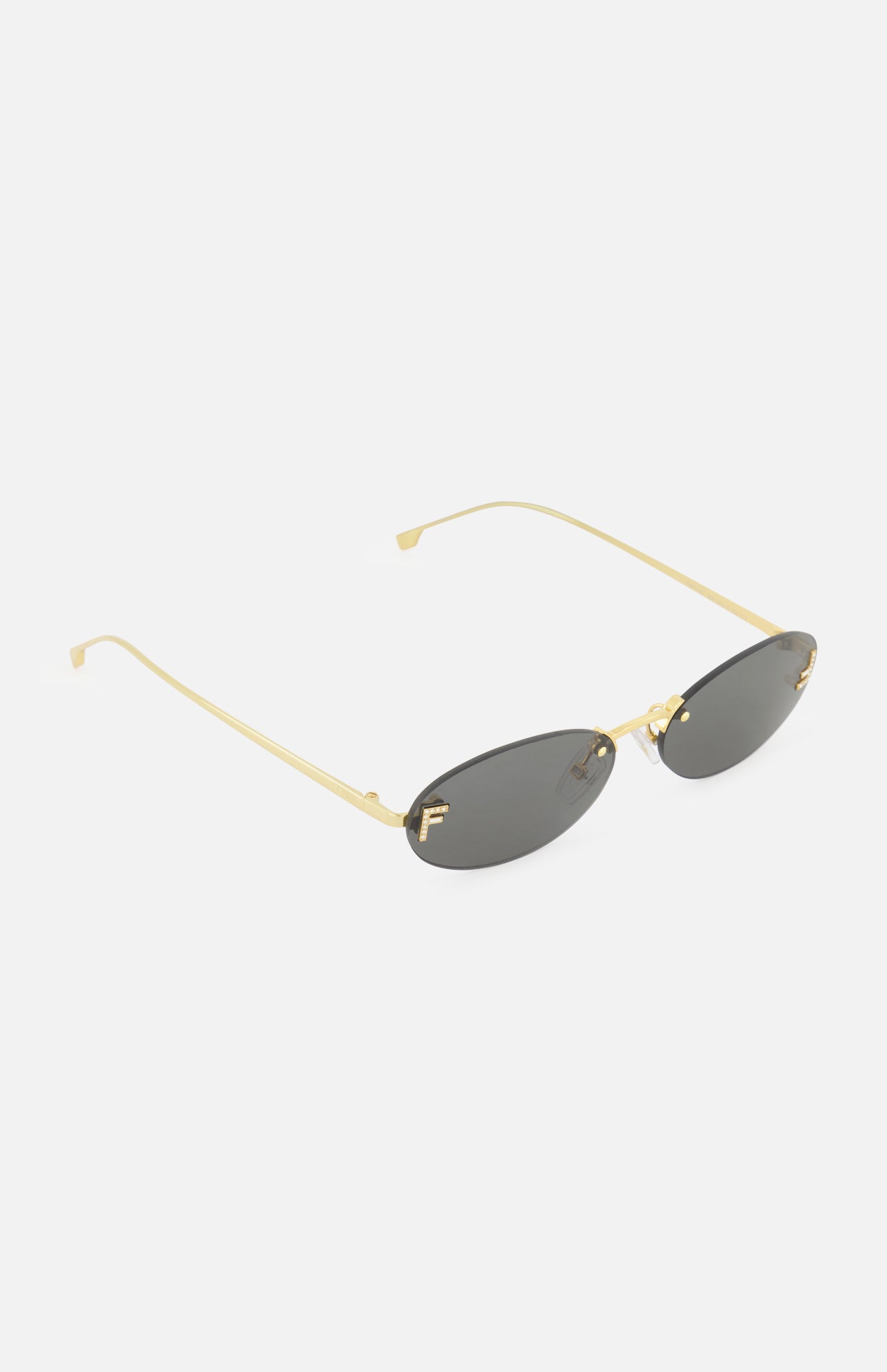 FENDI Oval Gold Sunglasses featuring a sleek gold metal oval frame, dark lenses, and thin arms, are displayed on a white background.