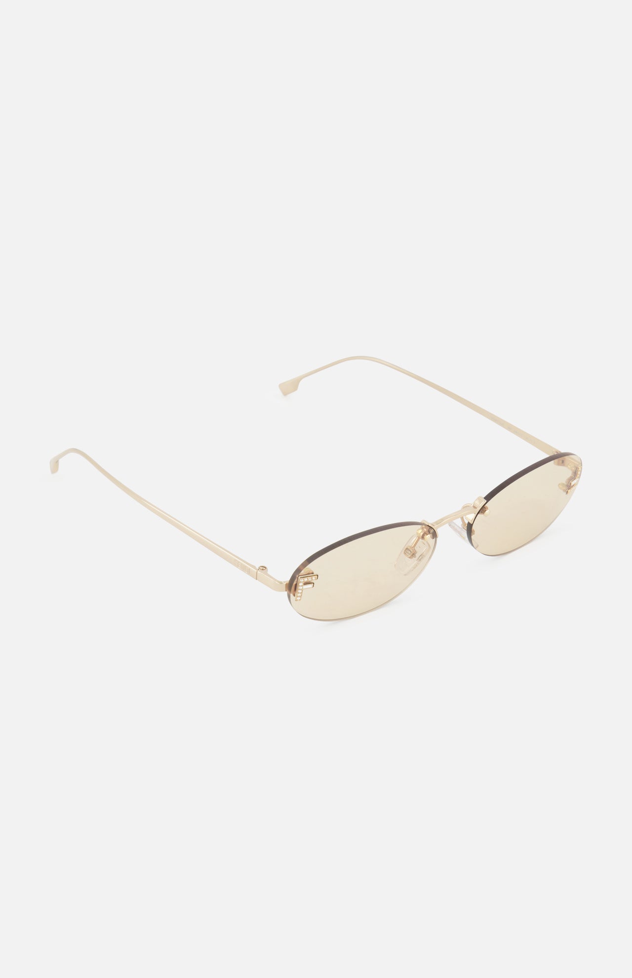A pair of FENDI Oval Rose Gold Sunglasses, featuring rimless oval frames, light brown tinted lenses, and thin rose gold metal arms, displayed on a white background.
