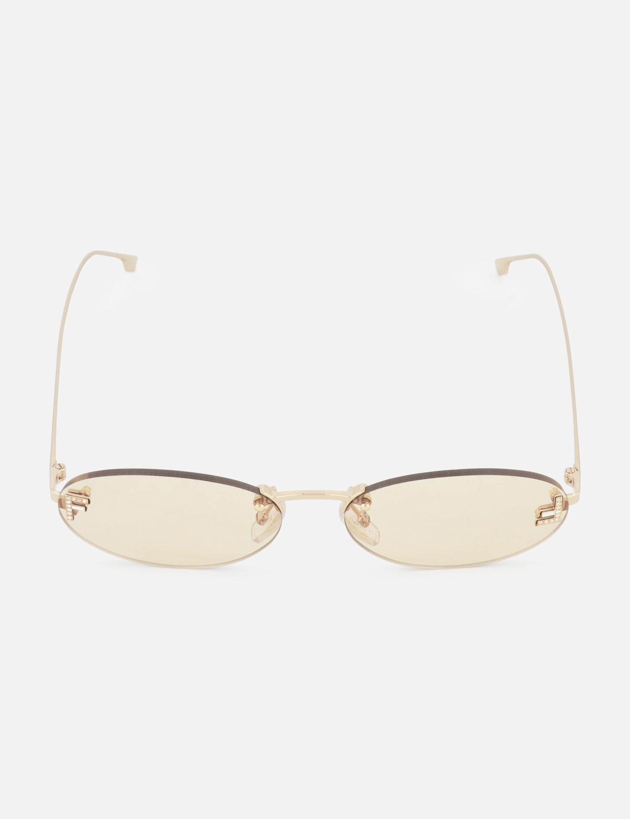 The FENDI Oval Rose Gold Sunglasses feature thin, rose gold metal frames and light yellow-tinted lenses, displayed against a plain white background.