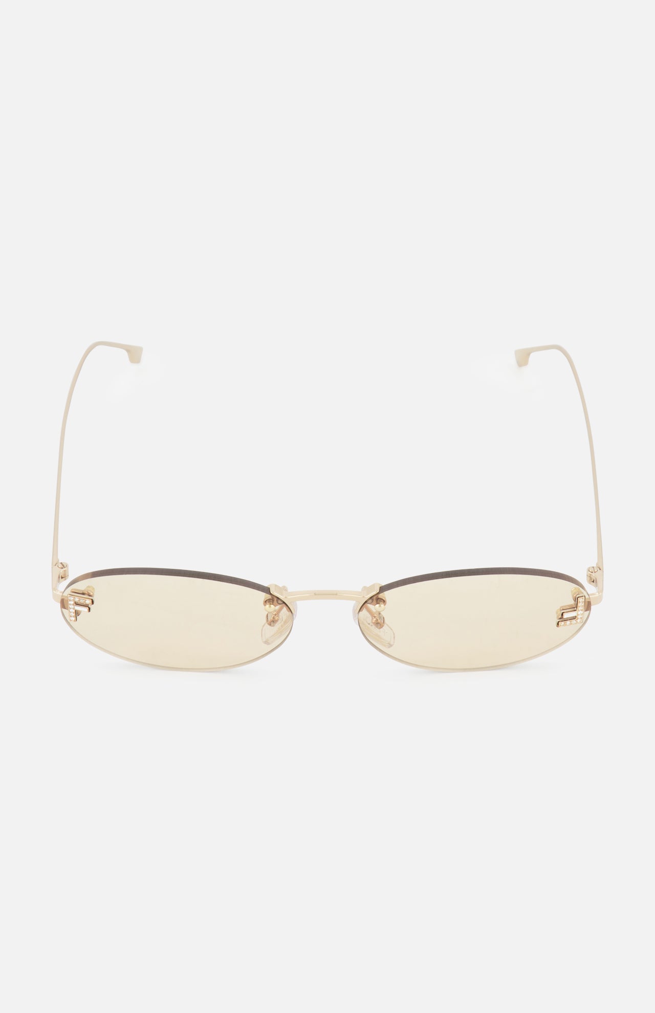 The FENDI Oval Rose Gold Sunglasses feature thin, rose gold metal frames and light yellow-tinted lenses, displayed against a plain white background.