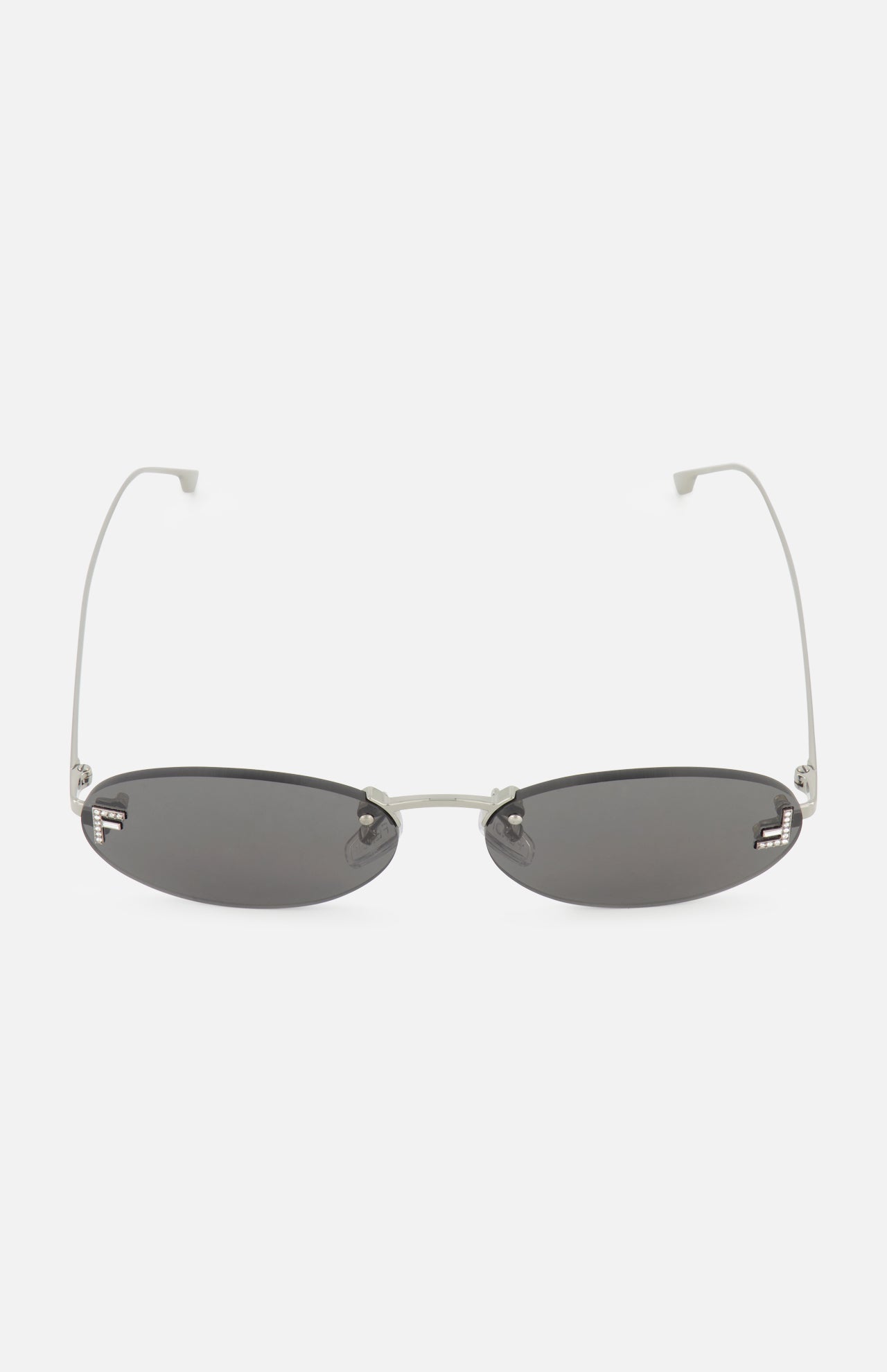 Fendi Oval Silver Sunglasses by FENDI featuring thin silver metal arms and black tinted lenses, showcased on a white background.