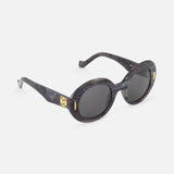 LOEWE Round Grey-black Sunglasses feature oval-shaped, marble-inspired thick black frames, dark grey lenses, and gold accents on the hinges, shown against a white background.
